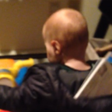 A Toddler Gets His Book Stuck In His Hoodie
