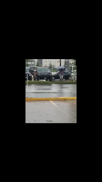 Woman Walks Through Car Park And Falls In Puddle