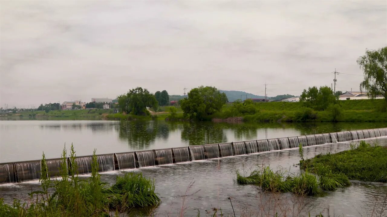 Gentle rain at a small dam in the river