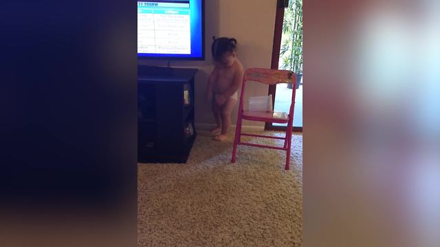 Cute Girl Trying To Fix The TV