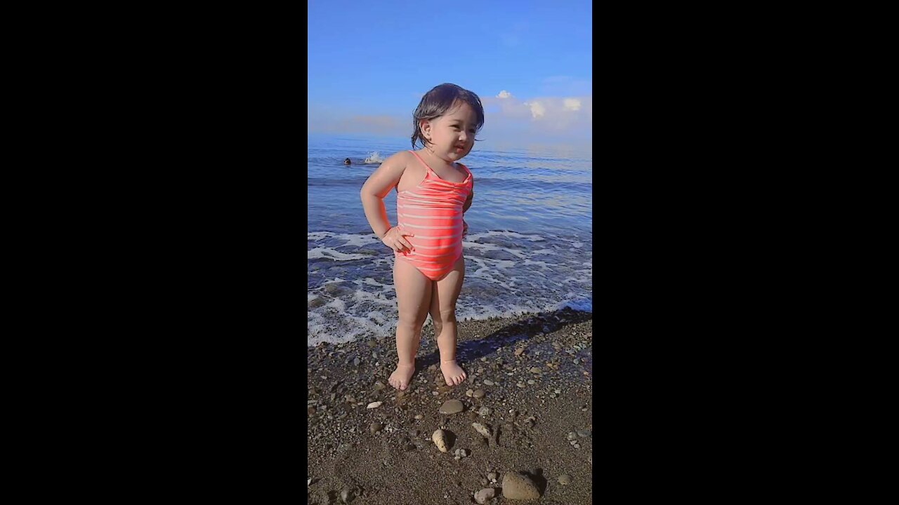 Lovely baby dancing on the beach