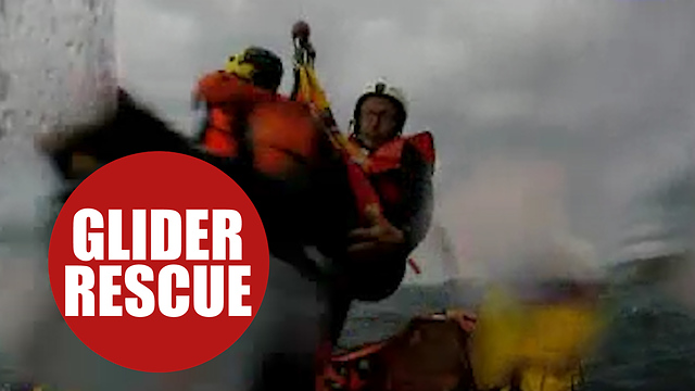 Paraglider being rescued from the sea by RNLI after inflight failure