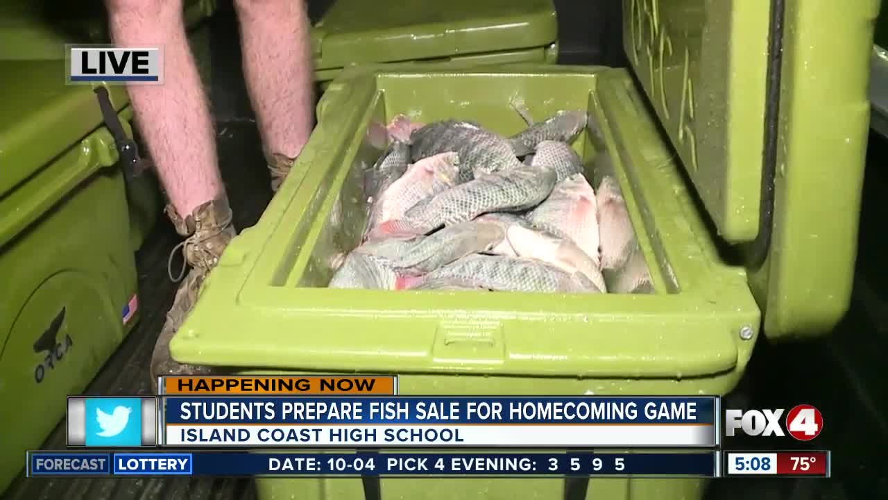 Students at Island Coast High School prepare fish to sell at homecoming game