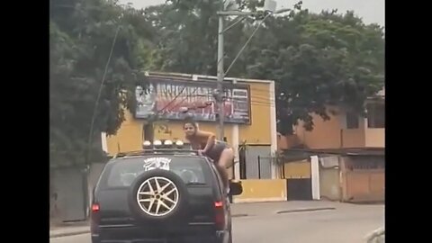 Brazilian Babe Picked A Bad Time To Climb On Top Of The SUV