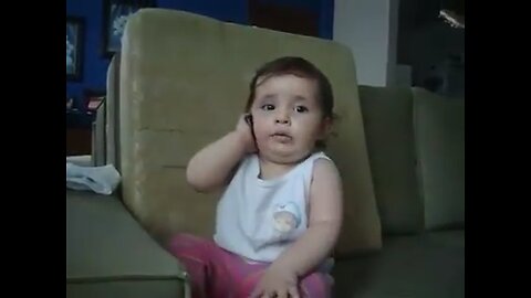Funny baby talking over the ph