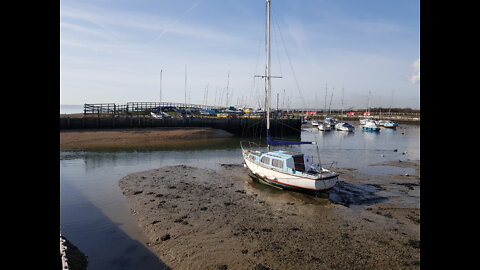 Coffee time L. Sitting on a picnic table by sea