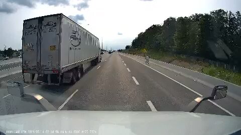 Cyclist Riding On Highway 401