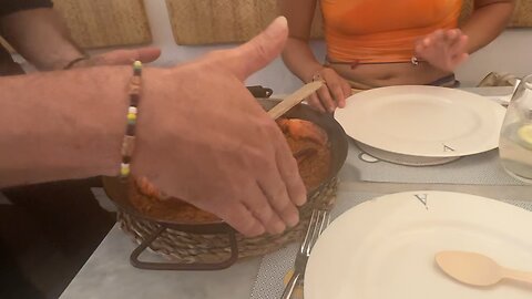 Indian Eating Lobster Paella With Spanish girl