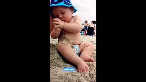 Funny baby reaction on the beach