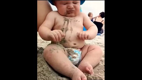 Funny baby reaction on the beach||