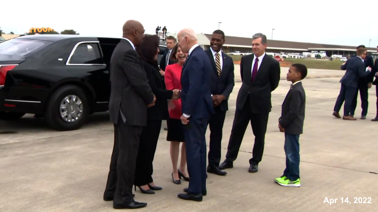A black child used as a prop on Biden's arrival.