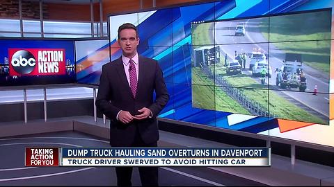 Sand truck overturns on highway in Davenport