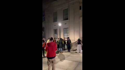 Antisemitic students make a chain blocking Jewish Professor from entering the school grounds.