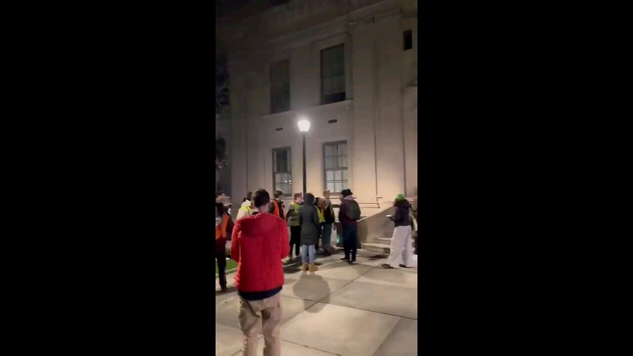 Antisemitic students make a chain blocking Jewish Professor from entering the school grounds.