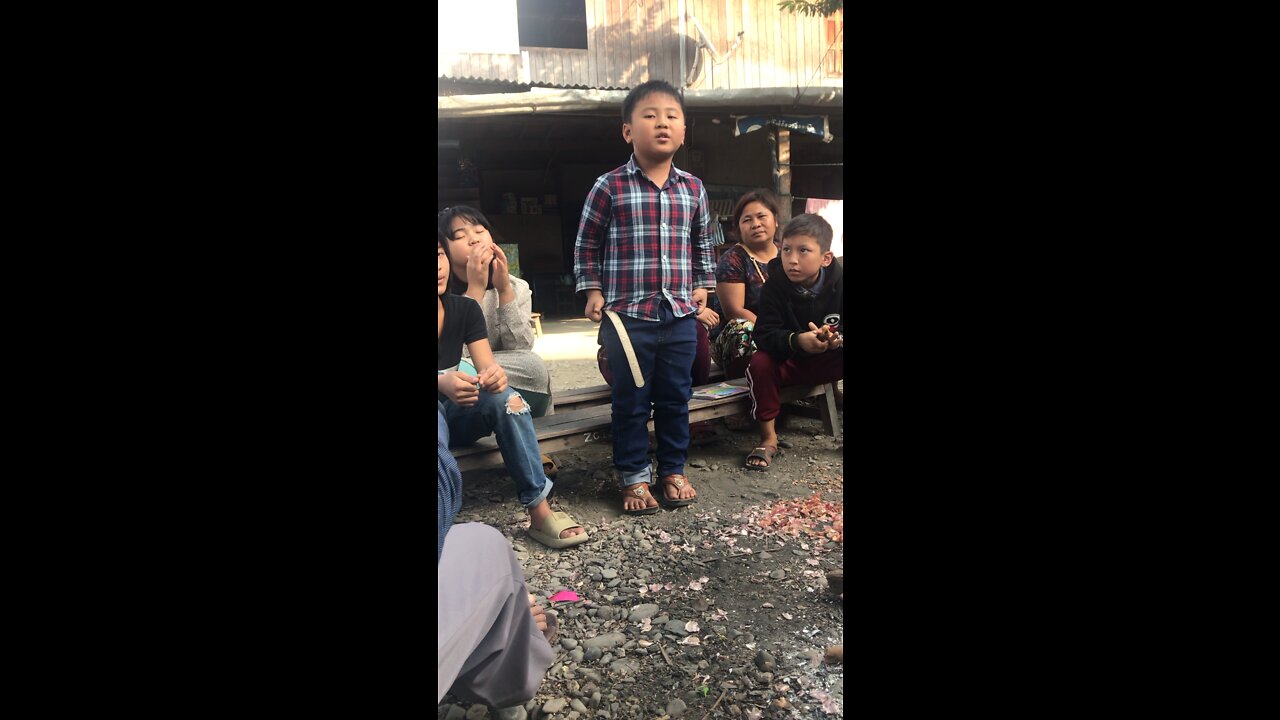 Burmese Boy Sings a Song by the fire