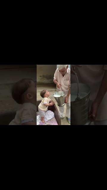 Cute beby drinking milk from big jar