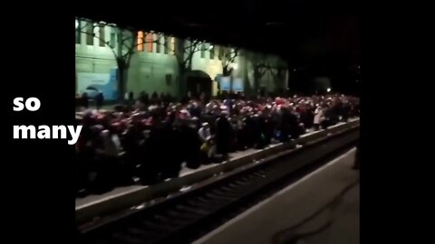 Ukrainian People escaping the War. They wait calmly for a train.
