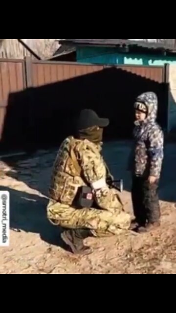 Russian soldier care for Ukrainian Child