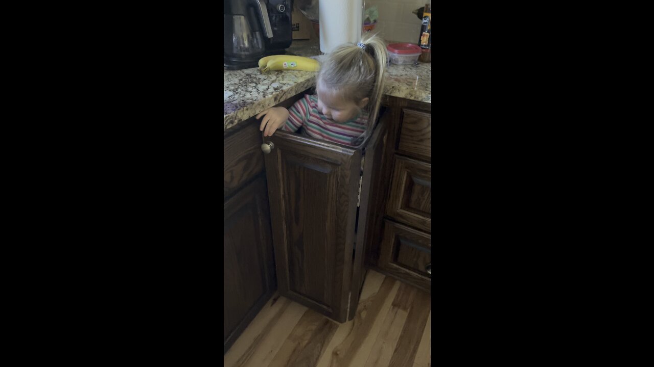 Evie in her cupboard house.