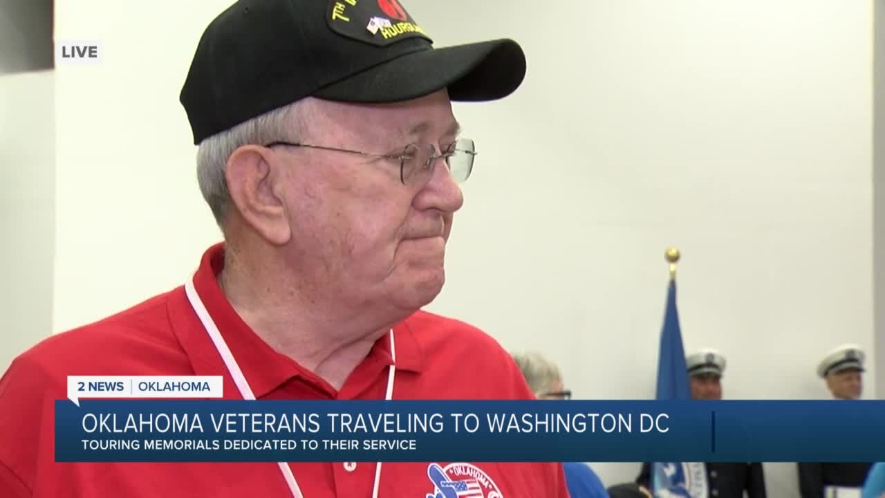 Justin Fischer speaks with a vet about to board today's Honor Flight