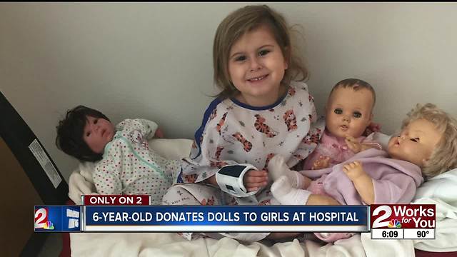 Young girl gifting dolls to kids at St. Francis