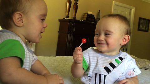 Twin Teases Brother With Lollipop