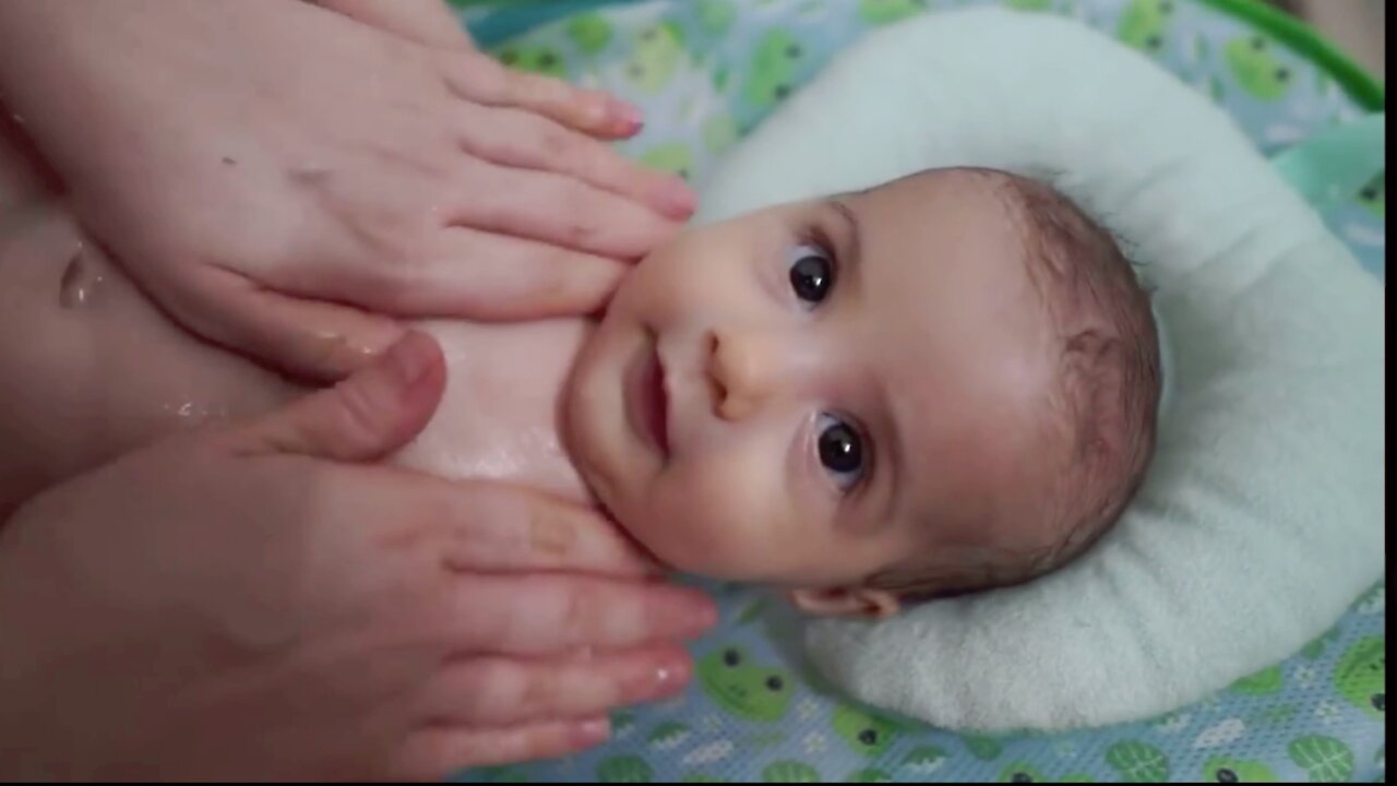 Adorable Baby Girl can’t stop looking at her mom while she takes bath