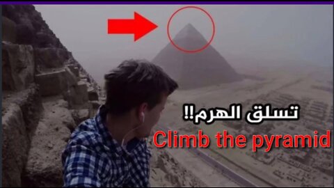 A young man climbs the pyramids of Giza in Egypt