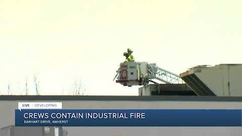 Fire crews continue to battle warehouse fire in Amherst