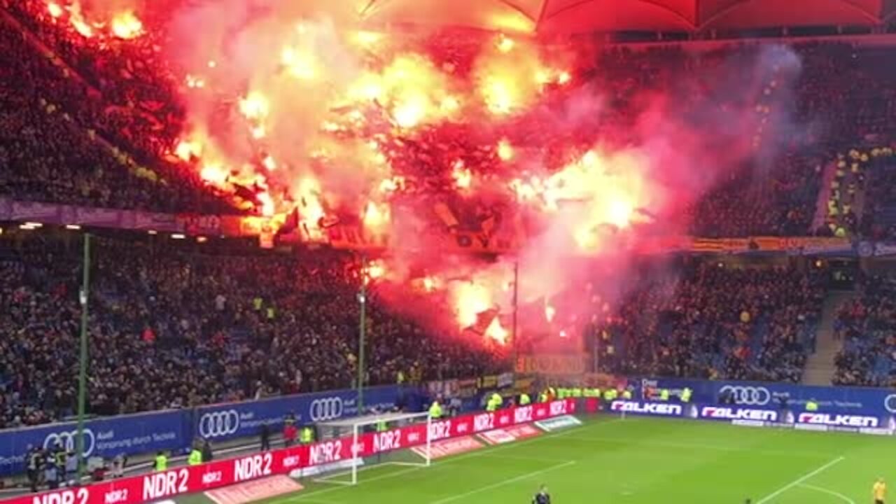 German soccer fans light up massive section of seats with flares