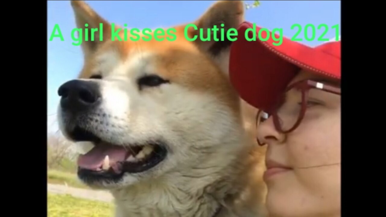 A girl kisses Cutie Dog 2021