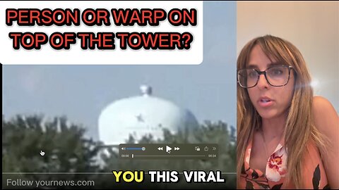 Is this a person or a pixelation warp on top of the water tower?