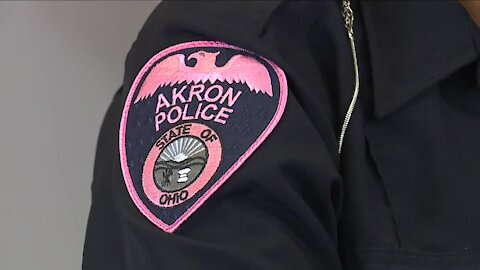 Akron police officers wearing pink patches for breast cancer awareness month