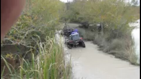 Mudaholic convention cleaning out a hole on water trail