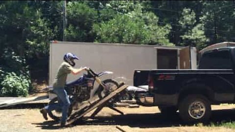 Ramp breaks while loading motorcycle onto truck