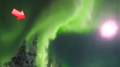 The moon and beautiful aurora borealis over the snowfield