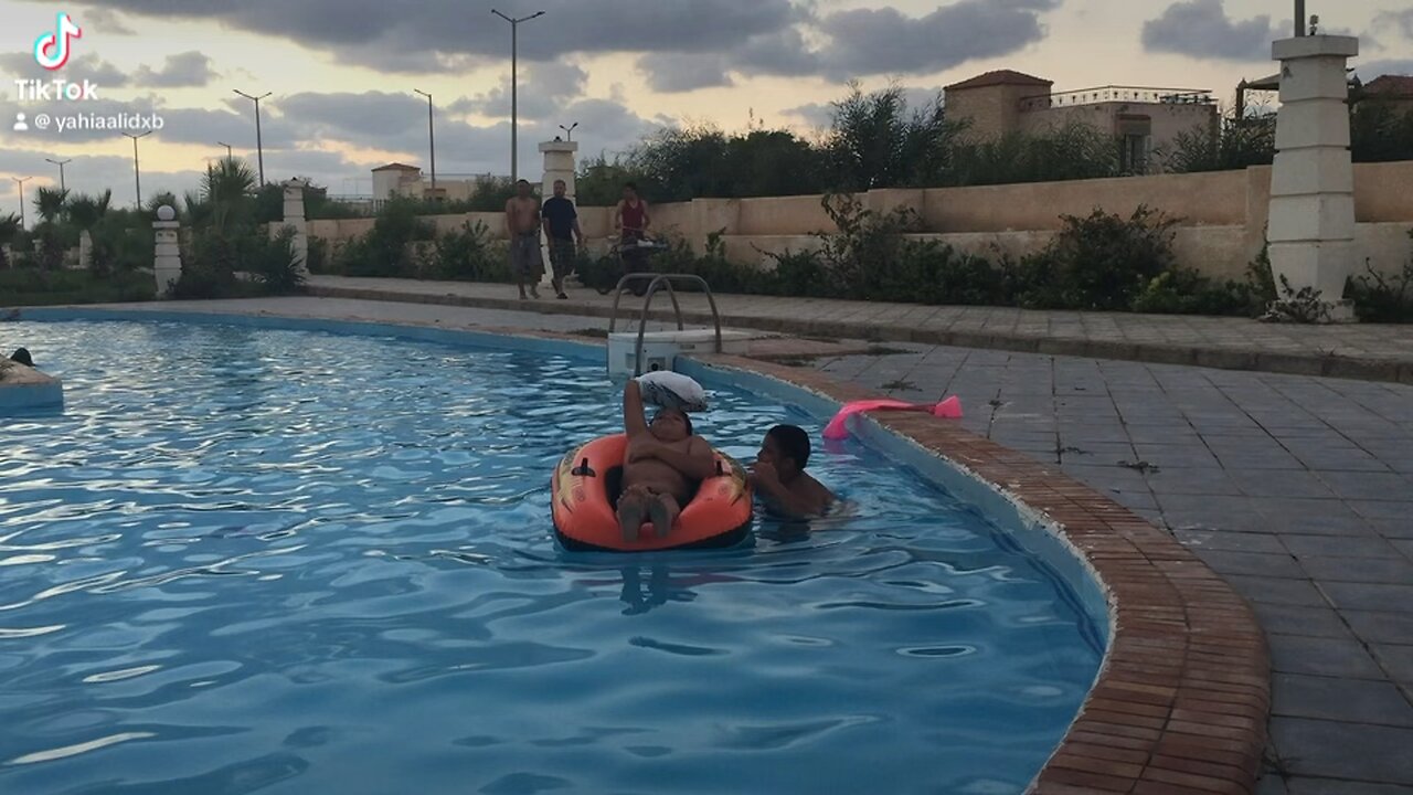 Me helping my brother be in the swimming pool while his hand was injured.