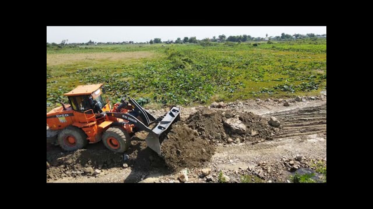 Big Heavy DISD SD300N Wheel Loader Pushing Gravel Rock Building New Road Across Huge Lake