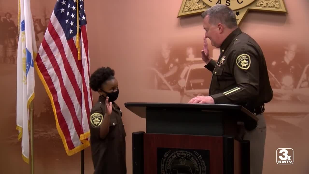 Moving Forward: 7-year-old girl sworn in as honorary deputy for Douglas County Sheriff’s Office