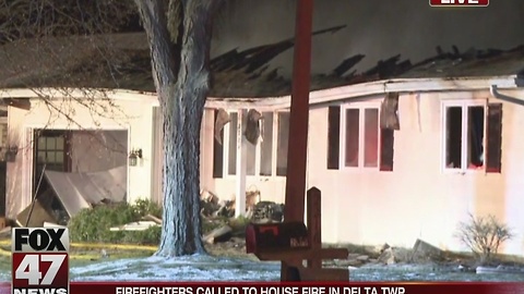 Crews battle fire at house in Delta Township