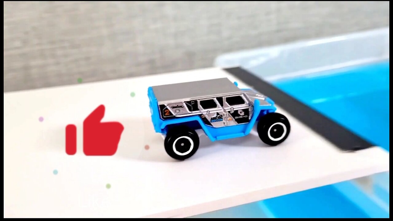 small scale cars going down on the slope and fall into water on top of each other