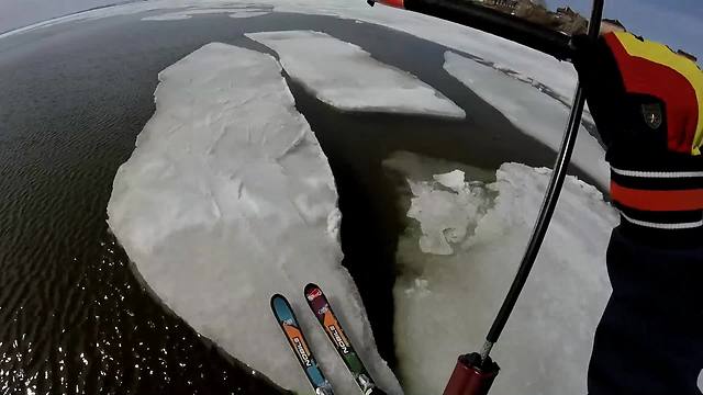 Daredevils kite skate over semi-frozen water