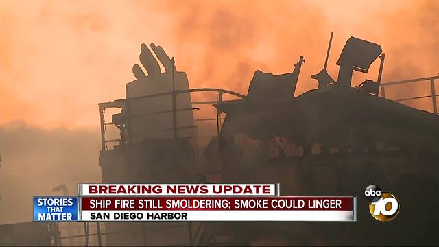 Ship fire still smoldering, smoke could linger