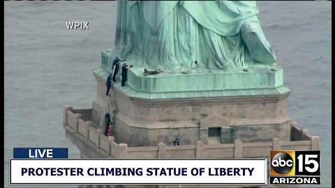 Protester climbs Statue of Liberty