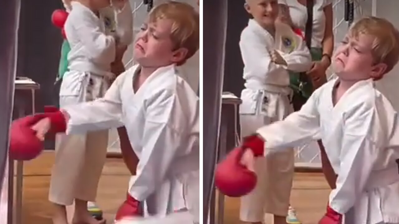 Kid clearly not too thrilled to be at kickboxing class