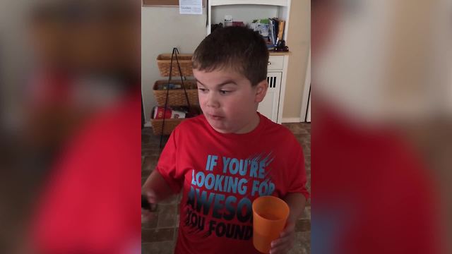 "Young Boy Challenges Himself with a Jalapeno Pepper"