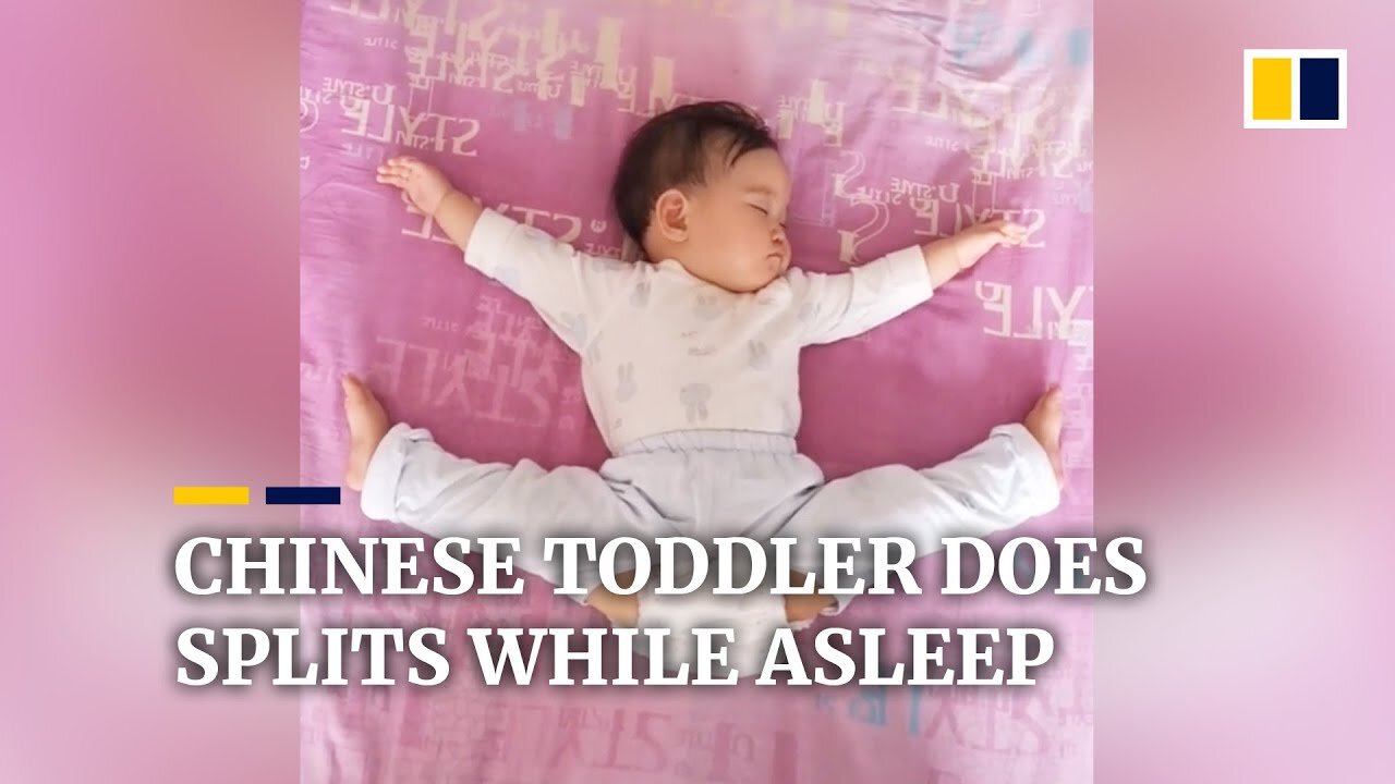 A one-year-old girl doing splits while she is sleeping