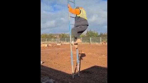 Lad Tries To Climb Freestanding Ladder