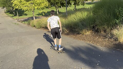 Yung Alone Riding Longboard Down Hill At Riverfront