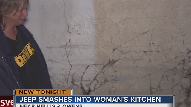 Driver of SUV smashes through woman's kitchen